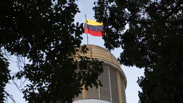 A national flag of Venezuela flies atop the National Assembly building during parliamentary elections in Caracas, Venezuela, on Sunday, Dec. 6, 2020.  Photographer: Carlos Becerra/Bloomberg