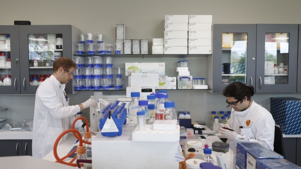 Drug discovery scientist Phillipp Schafer (L) and protein scientist Simon Varzandeh (R) work in the laboratory of British pharmatech company Exscientia at Oxford Science Park in Oxford, in southern central England, on April 24, 2020 as part of the company's joint initiative to test existing clinical molecules to find a treatment for the COVID-19 illness.  Photographer: Adrian Dennis/AFP/Getty Images