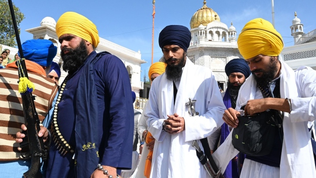 Amritpal Singh, center, at the Golden Temple in Amritsar, on March 3. Photographer: Narinder Nanu/AFP/Getty Images