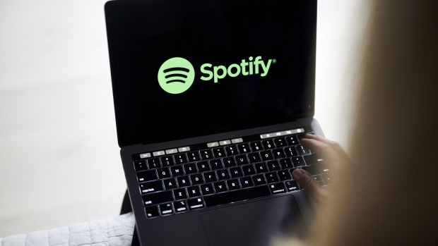 The logo for Spotify is displayed on a laptop computer in an arranged photograph taken in Little Falls, New Jersey, U.S., on Wednesday, Oct. 7, 2020. Spotify has invested hundreds of millions of dollars acquiring podcast studios such as Gimlet Media and the Ringer, hoping to attract new users and advertisers to what has been a music app. Photographer: Gabby Jones/Bloomberg