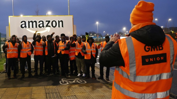 Amazon workers pose for a photograph during a strike over pay at the Amazon.com Inc. fulfilment centre in Coventry, UK, on Tuesday, Feb. 28, 2023. The walkout is timed to maximize disruption for Easter weekend and slow product delivery, a GMB spokesperson told Bloomberg.