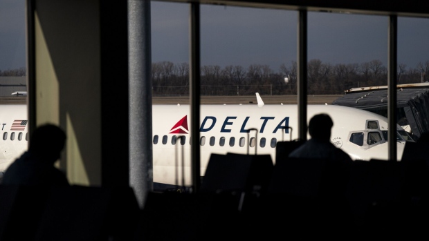 A Delta Air Lines Inc. plane at a gate after the Federal Aviation Administration (FAA) lifted a ground stop at Bill and Hillary Clinton National Airport (LIT) in Little Rock, Arkansas, US, on Wednesday, Jan. 11, 2023. Airlines began resuming flights after a system outage led US authorities to temporarily ground planes nationwide early Wednesday, a dramatic disruption to the air-traffic system expected to cause ongoing delays and cancellations.