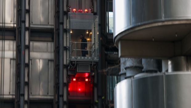 A worker in a lift at the Lloyd's of London Ltd. building in the City of London, U.K., on Tuesday, Jan. 18, 2022. Lloyd’s of London is reviewing its real estate needs as the historic insurance market embraces flexible working.