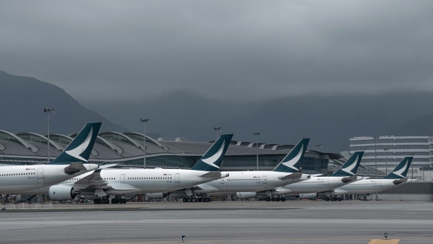 Aircraft operated by Cathay Pacific Airways Ltd. at Hong Kong International Airport in Hong Kong, China, on Friday, Nov. 25, 2022. Hong Kong's new, third runway, which opened in July, is part of a HK$141.5 billion ($18 billion) project that will increase its footprint by 50%, adding 650 hectares (1,606 acres), equivalent to the size of Gibraltar. Photographer: Bertha Wang/Bloomberg