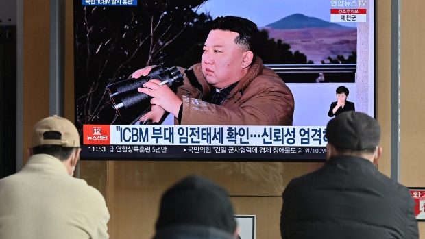 People watch a television news screen showing a picture of North Korea's leader Kim Jong Un witnessing the recent test-firing of a Hwasong-17 intercontinental ballistic missile (ICBM), at a railway station in Seoul on March 17, 2023.  Photographer: Jung Yeon-Je/AFP/Getty Images