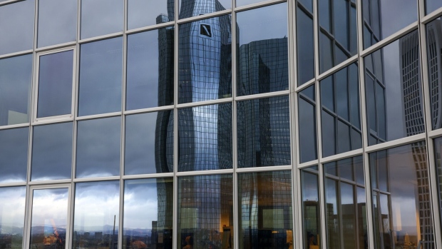 The headquarters of Deutsche Bank AG reflected in the windows of an office building in the financial district of Frankfurt, Germany, on Thursday, Feb. 2, 2023. Deutsche Bank vowed to increase profit and revenue further this year, after snapping a long streak of market share gains in trading in the final quarter of Chief Executive Officer Christian Sewing's turnaround plan. Photographer: Alex Kraus/Bloomberg