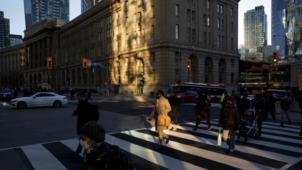 Morning commuters in downtown Toronto, Ontario, Canada, on Monday, Nov. 22, 2021. Many of Canada’s large financial firms say they have a growing portion of their workforces back in the office and the numbers are expected to swell in the New Year. Photographer: Cole Burston/Bloomberg