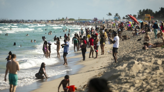 People gather on a beach in the South Beach neighborhood of Miami during spring break in March 2021.