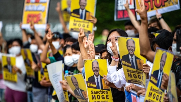 A group of activists demonstrate with placards calling the US government to sanction Myanmar's state-run Myanma Oil and Gas Enterprise ahead of US President Joe Biden's visit to Japan, in Tokyo on May 22, 2022. Photographer: Philip Fong/AFP/Getty Images
