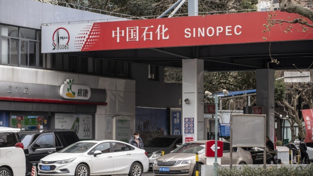 Vehicles refuel at a China Petroleum & Chemical Corp. (Sinopec) gas station in Shanghai, China, on Thursday, Jan. 7, 2021. China's energy markets are tightening as the economy rebounds and freezing weather grips much of the northern hemisphere, a dynamic that’s likely to be exacerbated by reduced Saudi oil output.