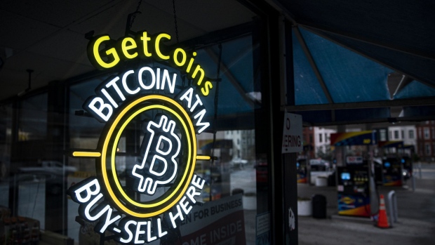 A sign for a Bitcoin automated teller machine (ATM) at a gas station in Washington, DC, US, on Thursday, Jan. 19, 2023. Bitcoin steadied after snapping a rare 14-day winning streak as a mood of caution supplanted the risk appetite that drove up a variety of assets at the start of the year.