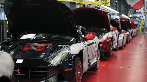 Protective covers sit on near-complete Ferrari automobiles as they stand on the production line at Ferrari SpA's plant in Maranello, Italy, on Wednesday, May 8, 2013.  Photographer: Alessia Pierdomenico/Bloomberg