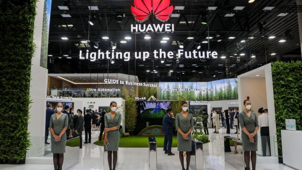 Workers wait for attendees by the entrance to the private Huawei Technologies Co. pavillion on the opening day of the MWC Barcelona at the Fira de Barcelona venue in Barcelona, Spain, on Monday, June 28, 2021. MWC Barcelona, which in 2019 attracted 109,000 attendees from 198 countries, was one of the first major European conference casualties due to the pandemic when it was axed in February last year. Photographer: Angel Garcia/Bloomberg