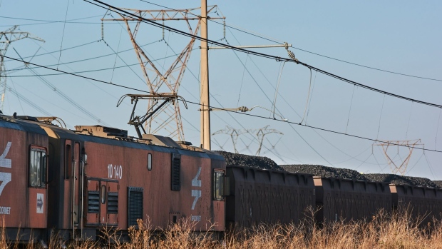 A Transnet SOC Ltd. freight train transports wagons of coal from the Mafube open-cast coal mine, operated by Exxaro Resources Ltd. and Thungela Resources Ltd., towards Richard's Bay coal terminal, in Mpumalanga, South Africa on Thursday, Sept. 29, 2022. South Africa relies on coal to generate more than 80% of its electricity, and has been subjected to intermittent outages since 2008 because state utility Eskom Holdings SOC Ltd. can't meet demand from its old and poorly maintained plants.