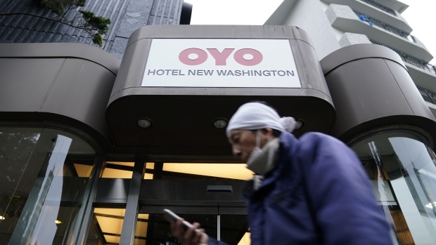 A pedestrian walks past an Oyo hotel, operated by Oyo Hotels Japan G.K., in Tokyo, Japan, on Monday, Jan. 27, 2020. Oyo has drawn particular attention in SoftBank Group Corp.’s portfolio of startups because of its similarities to WeWork. Both are trying to change traditional real estate businesses with technology. Both have charismatic young founders. Now, skeptics say Oyo could also fall short, further undermining Son’s grand ideas about technology investing.