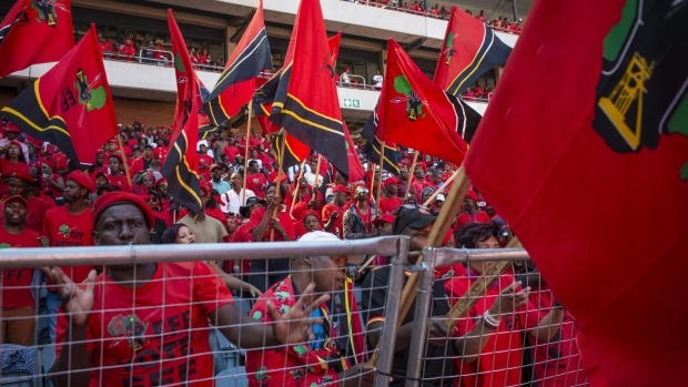 Attendees wear red campaign shirts and wave flags at an Economic Freedom Fighters party campaign rally in Soweto, Johannesburg, South Africa, on Sunday, May 5, 2019. With the winner of South Africas May 8 elections hardly in doubt, it's uncertainty around the margin of victory for the ruling African National Congress that has stock investors attention.