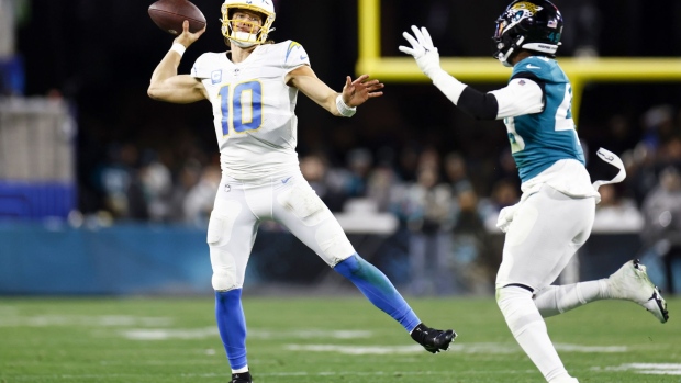 JACKSONVILLE, FLORIDA - JANUARY 14: Justin Herbert #10 of the Los Angeles Chargers throws a pass against the Jacksonville Jaguars during the second half of the game in the AFC Wild Card playoff game at TIAA Bank Field on January 14, 2023 in Jacksonville, Florida. (Photo by Douglas P. DeFelice/Getty Images)