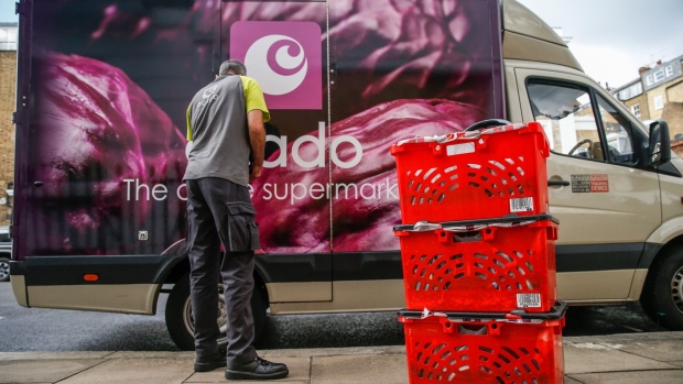 A delivery driver for Ocado Group Plc prepares groceries for delivery to an apartment in London, U.K., on Tuesday, Sept. 29, 2020. Covid-19 lockdown enabled online and app-based grocery delivery service providers to make inroads with customers they had previously struggled to recruit, according the Consumer Radar report by BloombergNEF.