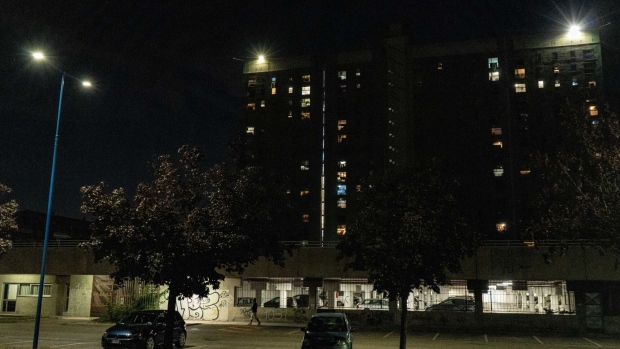 Street lights lit up outside a residential tower block at night in Brescia, Italy, on Sunday, July 3, 2022. Italy's government plans further measures to cushion the impact of high energy prices, including extending a fuel tax holiday to the beginning of October, Il Messaggero newspaper reported. Photographer: Francesca Volpi/Bloomberg