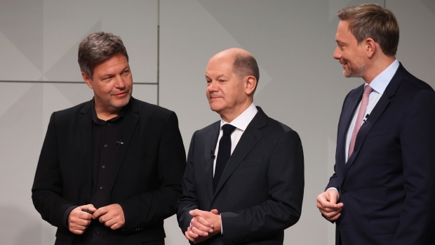 Olaf Scholz, Germany's incoming chancellor, center, Robert Habeck, co-leader of the Green Party, left, and Christian Lindner, Germany's finance minister, attend a signing ceremony of the coalition agreement to form a government in Berlin, Germany, on Tuesday, Dec. 7, 2021. Scholz cleared the final hurdle on his path to becoming German chancellor when Green Party members overwhelmingly approved their coalition deal with his center-left Social Democrats and the pro-business Free Democrats. Photographer: Liesa Johannssen-Koppitz/Bloomberg