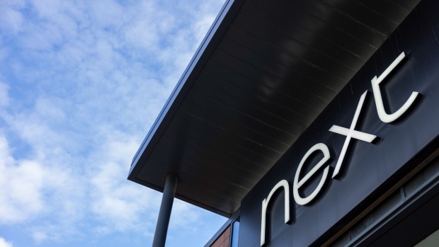 A Next Plc sign above an entrance to a clothing store in Guildford, UK, on Monday, March 27, 2023. Next are due to release their preliminary full year results on Wednesday. Photographer: Jason Alden/Bloomberg