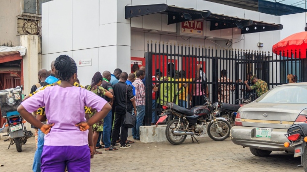 Customers queue to withdraw newly-designed Nigerian naira banknotes from automated teller machines (ATM) outside a Zenith Bank Plc branch in Lagos, Nigeria, on Saturday, Feb. 4, 2023. Central Bank Governor Godwin Emefiele has defended his decision to replace 2.7 trillion naira ($5.85 billion) of cash outside the banking system even as scenes of chaos have unfolded all over Nigeria, where the vast majority of transactions are still done in cash. Photographer: Benson Ibeabuchi/Bloomberg