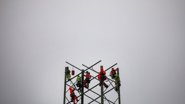Workers assemble a high voltage electricity transmission tower in Klockow, Germany, on Tuesday, April 5, 2022. Germany's cabinet approved a package of measures on April 6 aimed to make the country independent of fossil fuels by 2035. Photographer: Krisztian Bocsi/Bloomberg