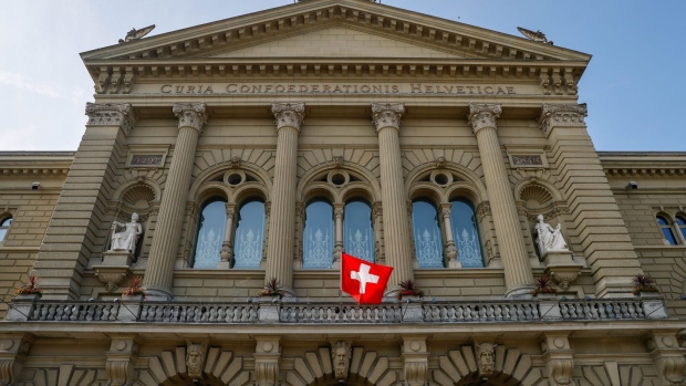 The Swiss national flag at the Federal Palace, Switzerland's parliament building, in Bern, Switzerland, on Thursday, June 17, 2021. The Swiss National Bank kept up its ultra-expansive monetary-policy stance aimed at thwarting any appreciation of the franc and insisted that any nascent inflation pressures it’s seeing won’t endure.