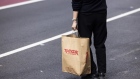 A pedestrian carries a TJ Maxx shopping bag in the SoHo neighborhood of New York, US on Wednesday, March 22, 2023. US retail sales fell in February after a surge in the prior month, suggesting consumer spending, while holding up, is getting challenged by high inflation. Photographer: Angus Mordant/Bloomberg