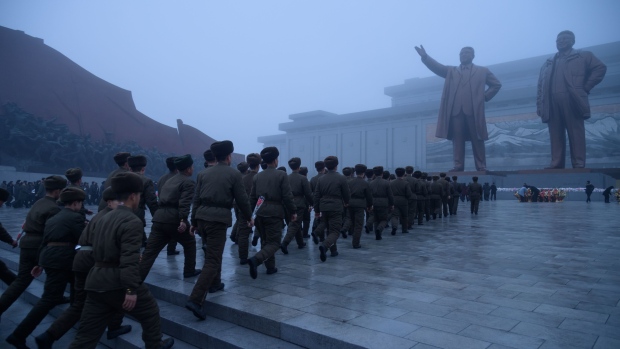  In a photo taken on December 17, 2019 Korean People's Army (KPA) soldiers pay their respects before a statue of late North Korean leader Kim Jong Il, on the anniversary of his death, at Mansu Hill in Pyongyang.  Photographer: Kim Won Jin/AFP/Getty Images