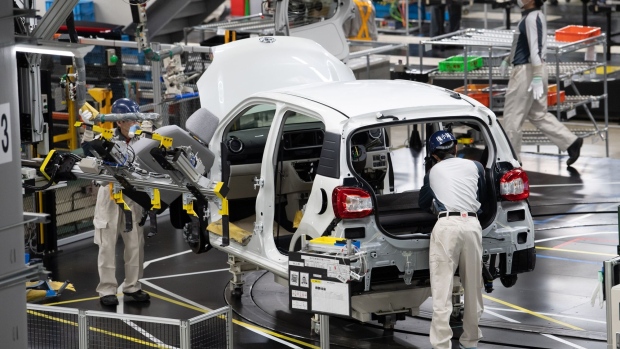 Workers assemble a Toyota Motor Corp. Passo vehicle on the production line at the Daihatsu Motor Co. Kyoto plant in Oyamazaki, Kyoto Prefecture, Japan, on Friday, Oct. 7, 2022. Daihatsu, wholly-owned subsidiary of Toyota Motor Corp., opened the renovated Kyoto plant to the members of media on Friday.