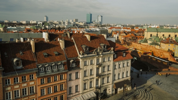 The city skyline beyond residential and commercial buildings in the old town in Warsaw, Poland, on Wednesday, Jan. 4, 2023. Poland left borrowing costs unchanged as the threat of an economic recession overshadows concerns over the highest inflation in more than a quarter century. Photographer Damian Lemański/Bloomberg Photographer: Damian Lemański/Bloomberg