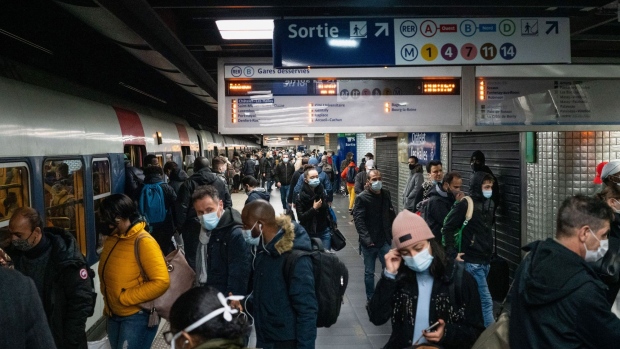 Commuters wait on a platform to board a train at an underground metro railway station in the La Defense business district of Paris, France, on Monday, Nov. 9, 2020. France's economy will take a smaller hit from the new lockdown to contain the spread of Covid-19 than it did during the tighter restrictions on activity earlier this year, according to the country’s central bank. Photographer: Benjamin Girette/Bloomberg