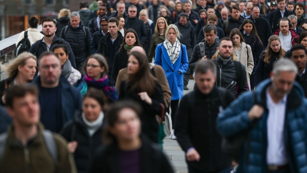 Commuters cross London Bridge in the City of London, UK, on Tuesday, March 21, 2023. The UK labor market showed some signs of cooling as wage growth slowed for the first time in more than a year. Photographer: Hollie Adams/Bloomberg