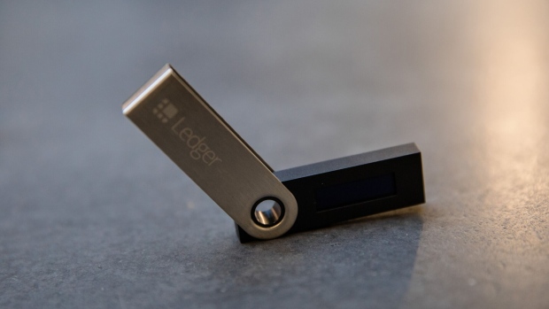 The Ledger SAS logo sits on a USB dongle used for safely storing and carrying around cryptocurrency passwords inside the technology startup company's headquarters in Paris, France, on Thursday, Jan. 25, 2018. Ledger, a startup that makes electronic wallets for Bitcoin and other cryptocurrencies, has raised 61 million euros ($75 million) from investors including Draper Esprit Plc. Photographer: Marlene Awaad/Bloomberg