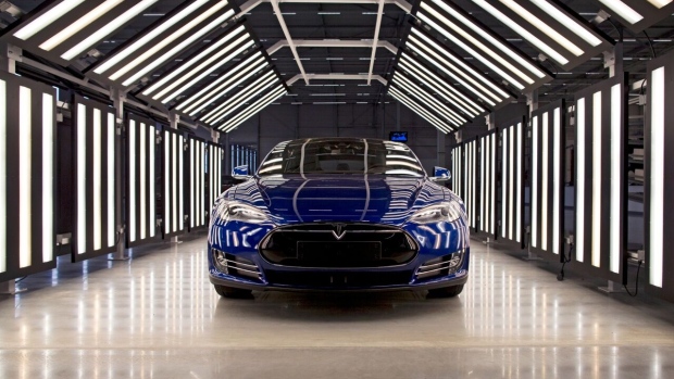 A Tesla Model S automobile stands in a light tunnel during quality control checks ahead of European shipping from the Tesla Motors Inc. factory in Tilburg, Netherlands, on Thursday, Oct. 8, 2015. Tesla said it delivered 11,580 vehicles in the third quarter, meeting its target after Chief Executive Officer Elon Musk handed over the first Model X sport utility vehicles just before the end of the period.