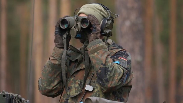 PABRADE, LITHUANIA - OCTOBER 27: A tank commander looks through binoculars on a Leopard 2A6 main battle tank of the Bundeswehr, the German armed forces, during the NATO Iron Wolf military exercises on October 27, 2022 in Pabrade, Lithuania. Germany leads a NATO contingent of troops in Lithuania under the Enhanced Forward Presence (eFP) battle group, with troops also from Belgium, the Czech Republic, the Netherlands, Luxembourg and Norway. (Photo by Sean Gallup/Getty Images)
