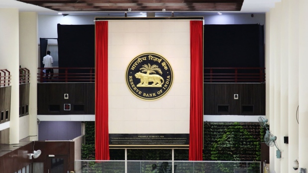 The Reserve Bank of India (RBI) logo is displayed on a wall inside the central bank's regional headquarters in New Delhi, India, on Monday, July 8, 2019. India's central bank governor Shaktikanta Das praised the federal government’s efforts to rein in the fiscal deficit, saying it would help avoid crowding out private investment. Photographer: T. Narayan/Bloomberg