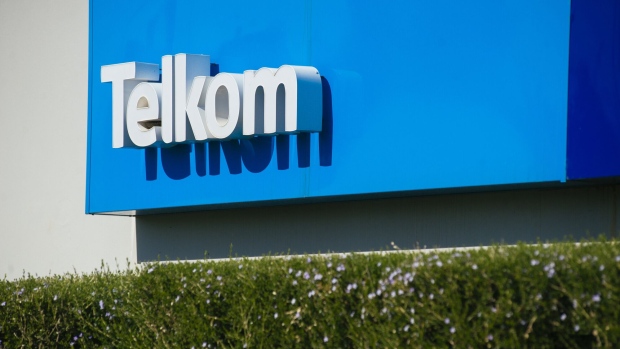 A sign stands at the entrance to the Telkom SA SOC Ltd. head office in the Centurion district of Johannesburg, South Africa, on Tuesday, July 25, 2017. South Africa is evaluating assets it could sell to pay for this month’s 2.2 billion rand ($169.5 million) bailout of unprofitable carrier South African Airways, Finance Minister Malusi Gigaba said in letter to parliament. Photographer: Waldo Swiegers/Bloomberg