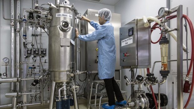 A researcher handles a Sartorius AG Biostat B plus bioreactors in a microbiology laboratory used by Taraph Technologies in Singapore, on Monday, July 1, 2019. Humans generated 2.01 billion tons of solid waste in 2016, about 12% of it was plastic, and by 2050 that could rise to 3.4 billion tons, according to the World Bank. Taraph Technologies is a start-up tackling the need for landfills and incinerators by harnessing natural enzymes that digest plastics and turn them into chemicals normally produced in oil refineries.