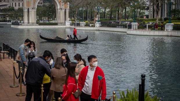 Visitors wait to take a ride on a gondola at the Venetian hotel resort, operated by Sands China Ltd., a unit of Las Vegas Sands Corp., on the Cotai Strip in Macau, China, on Wednesday, Jan. 25, 2023. Tourism and spending are reviving in Macau as the Lunar New Year holiday spurred a jump in visitors after pandemic travel restrictions were eased between the territory and mainland China.