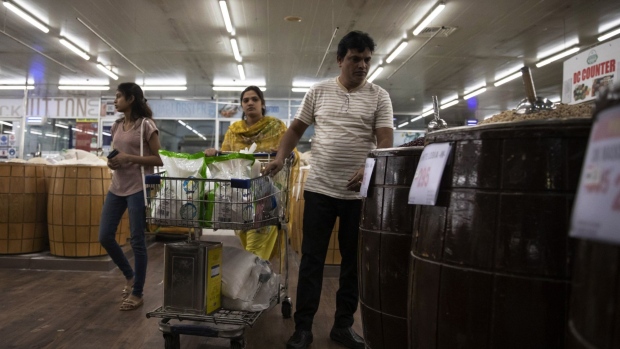 People shop at a supermarket in Lahore, Pakistan, on March 30, 2023. Rising inflation and tax hikes implemented to fulfill aid terms from the International Monetary Fund are eroding consumer purchasing power, according to Bloomberg Economics.