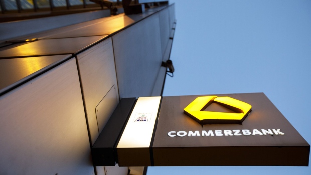 The Commerzbank AG logo sits on an illuminated sign outside the bank's headquarters at dusk in Frankfurt, Germany, on Monday, Feb. 5, 2017. Germany's second-largest bank reports annual results on Feb. 8. Photographer: Alex Kraus/Bloomberg