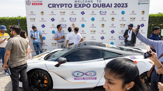 Attendees pass a luxury automobile while arriving at the Dubai Crypto Expo at the Festival Arena in Dubai, United Arab Emirates, on Wednesday, March 8, 2023. A long road lies ahead to repair confidence in crypto after unprecedented bankruptcies and hacks, including the major challenge of giving investors a way of insuring against such events.