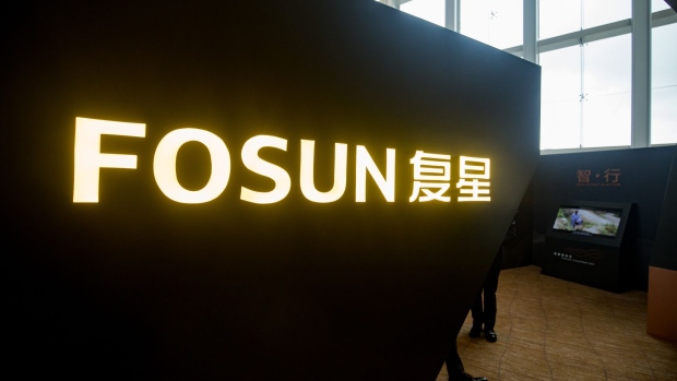 Fosun International Ltd. branding is displayed in an exhibition area during a news conference in Hong Kong, China, on Wednesday, Aug. 29, 2018. Fosun, the last of China's serial acquirers buying high-profile assets, reported higher profits amid gains from its investment division. Photographer: Paul Yeung/Bloomberg