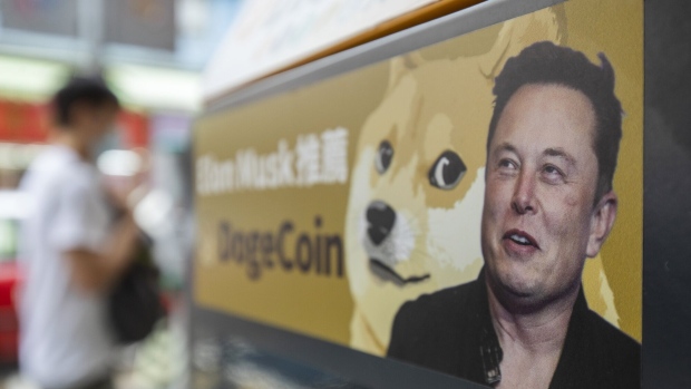 A sticker advertising Dogecoin on a cryptocurrency automated teller machine (ATM) at a laundromat in Hong Kong, China, on Thursday, June 9, 2022. Tesla Inc. Chief Executive Elon Musk expressed his interest in Bitcoin and Dogecoin early last year and allowed Tesla customers to buy the electric cars with Bitcoin, helping to send the crypto market to record highs. Photographer: Paul Yeung/Bloomberg
