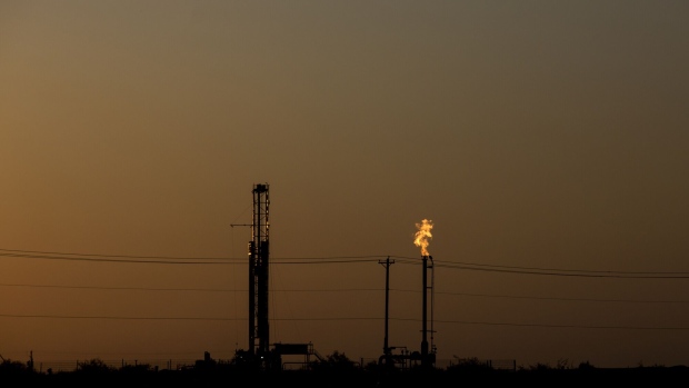A gas flare is seen in a field at dusk near Pecos, Texas, U.S., on Saturday, Aug. 31, 2019. Natural gas futures headed for the longest streak of declines in more than seven years as U.S. shale production outruns demand and inflates stockpiles. Photographer: Bronte Wittpenn/Bloomberg