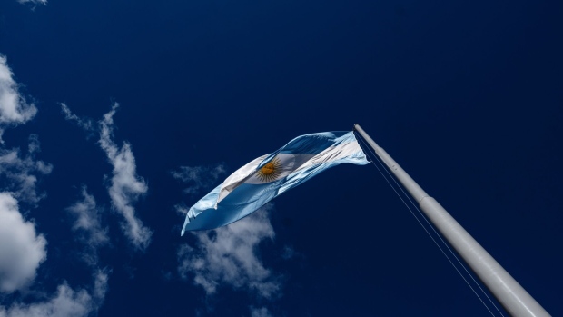 An Argentine flag stands on display in Plaza de Mayo in Buenos Aires, Argentina, on Tuesday, Aug. 13, 2019. In the wake of President�Mauricio Macri's stunning rout in primary elections over the weekend, investors dumped its stocks, bonds and currency en masse, leaving much of Wall Street wondering whether the country was headed for yet another default. Photographer: Erica Canepa/Bloomberg