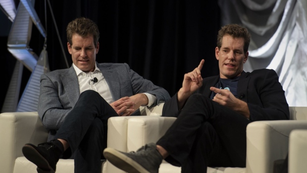 Cameron Winklevoss, president and co-founder of Gemini Trust Co., right, speaks as Tyler Winklevoss, chief executive officer and co-founder of Gemini Trust, looks on during the South By Southwest (SXSW) conference in Austin, Texas, U.S., on Friday, March 8, 2019. The SXSW conference provides an opportunity for global professionals at every level to participate, network, and advance their careers. Photographer: Callaghan O'Hare/Bloomberg