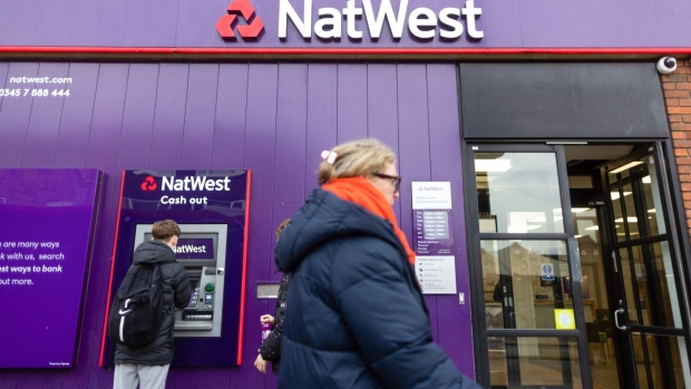 A customer uses an automated teller machine (ATM) at a NatWest Group Plc bank branch in Hornchurch, UK, on Friday, Feb. 10, 2023. Britain's major banks look set to post bumper results this month following a year of back-to-back interest rate hikes. Photographer: Chris Ratcliffe/Bloomberg